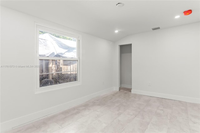 spare room with visible vents, baseboards, lofted ceiling, and recessed lighting