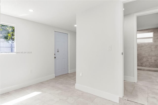 unfurnished room with baseboards and recessed lighting