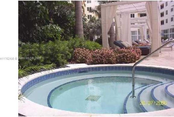 view of pool featuring a community hot tub