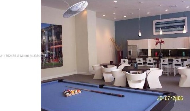 recreation room featuring billiards and a towering ceiling