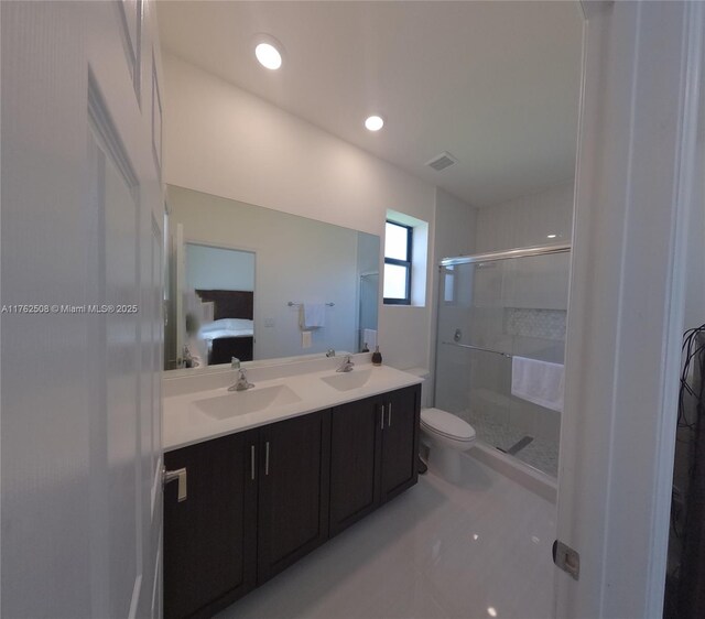 ensuite bathroom with visible vents, a stall shower, a sink, connected bathroom, and double vanity