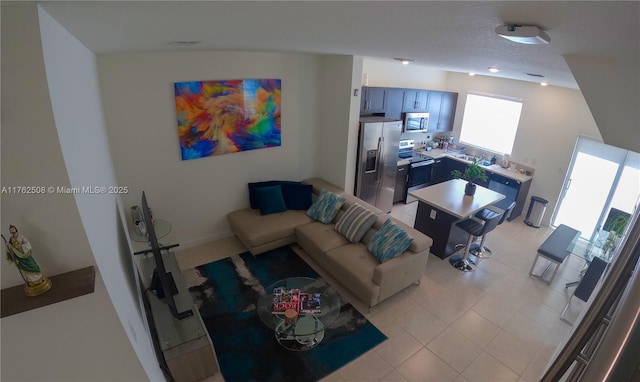 living room with light tile patterned floors and a textured ceiling