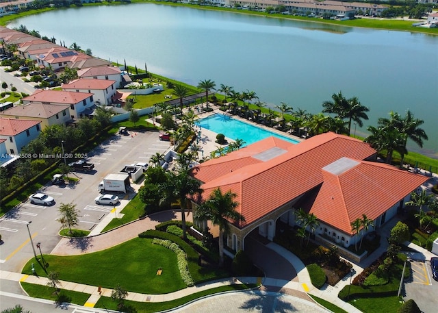 drone / aerial view with a residential view and a water view