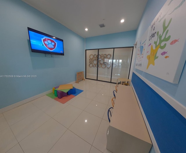 recreation room with tile patterned floors, recessed lighting, baseboards, and visible vents