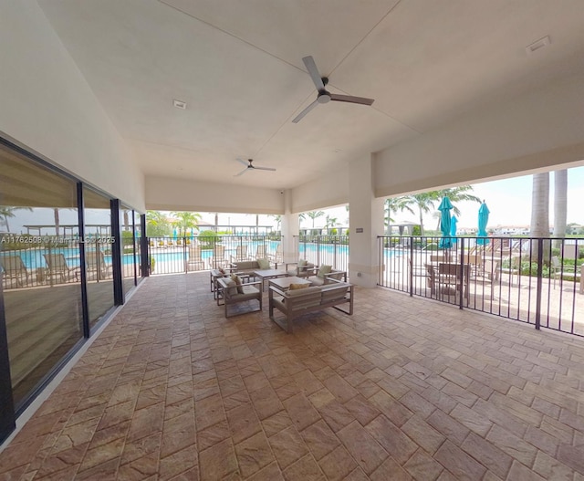 view of patio / terrace featuring a community pool, fence, and ceiling fan