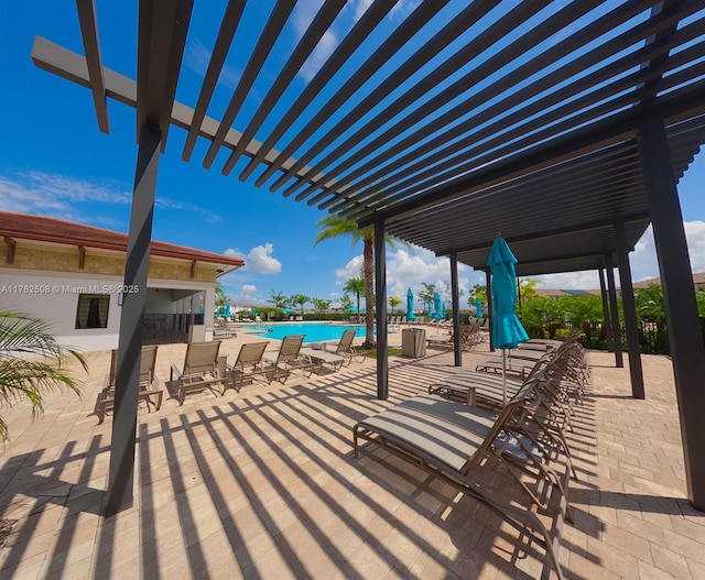 view of patio with a community pool and a pergola