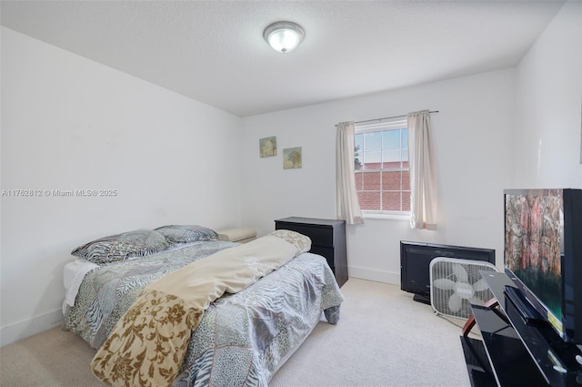 carpeted bedroom with baseboards and a textured ceiling