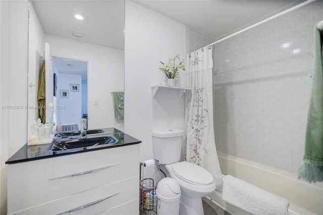 full bath featuring shower / bath combo with shower curtain, toilet, and vanity