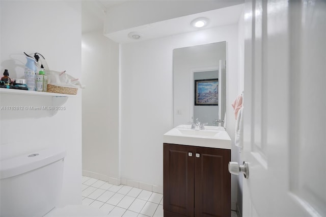 half bathroom with baseboards, toilet, vanity, and tile patterned flooring