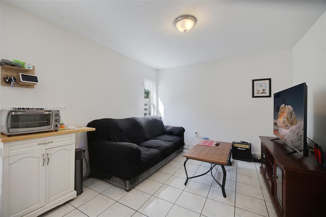 living room featuring light tile patterned flooring and a toaster