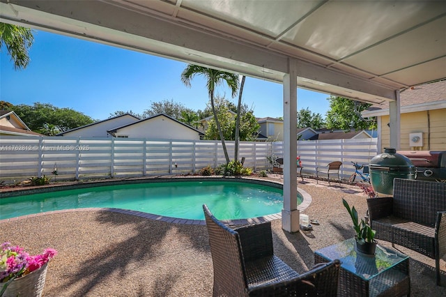 view of swimming pool featuring a fenced in pool, a patio, and a fenced backyard