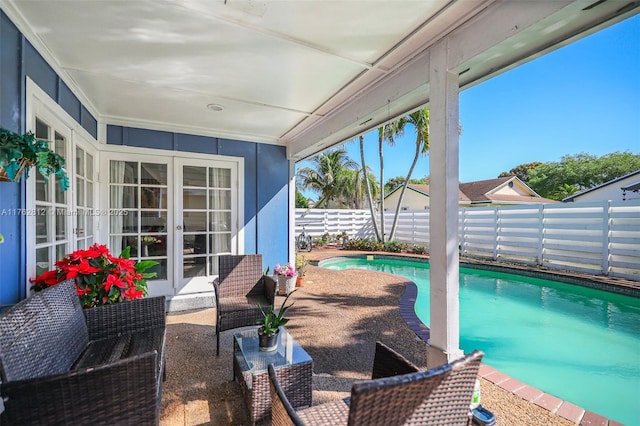 view of patio / terrace featuring french doors, a fenced in pool, and a fenced backyard