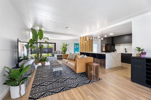 living room featuring light wood-style floors and visible vents