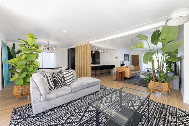 living area featuring a notable chandelier and light wood-style floors