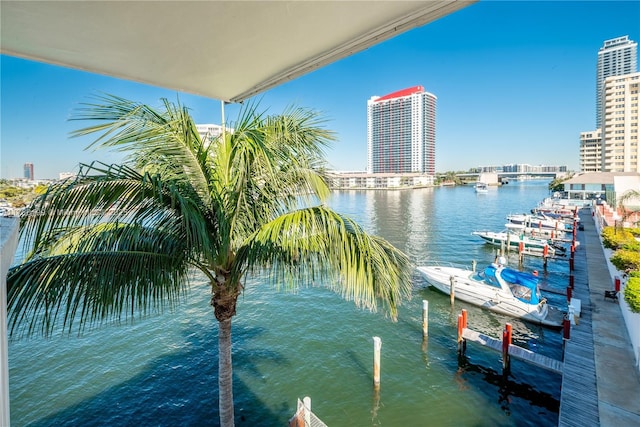 view of dock with a city view and a water view