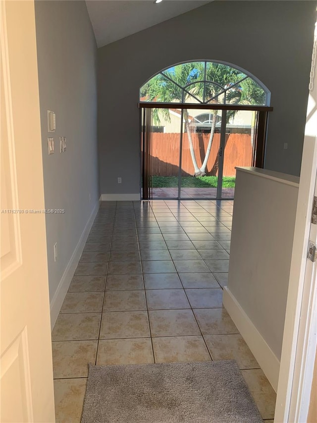 corridor featuring tile patterned floors and baseboards