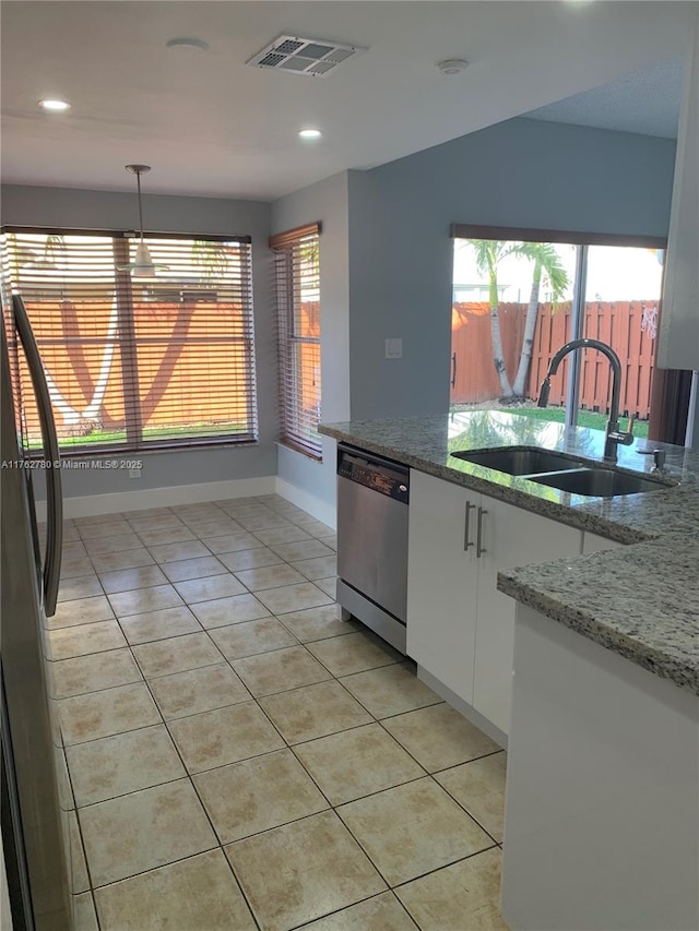 kitchen with light tile patterned floors, visible vents, a sink, white cabinets, and dishwasher