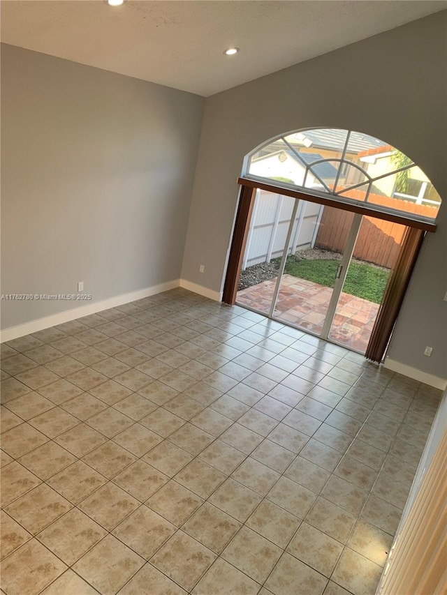 spare room with light tile patterned flooring, recessed lighting, and baseboards