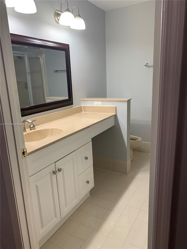 full bath with toilet, a stall shower, vanity, and tile patterned flooring