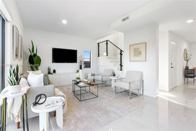 living area featuring visible vents, recessed lighting, stairway, and baseboards