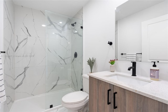 bathroom featuring a marble finish shower, toilet, marble finish floor, and vanity