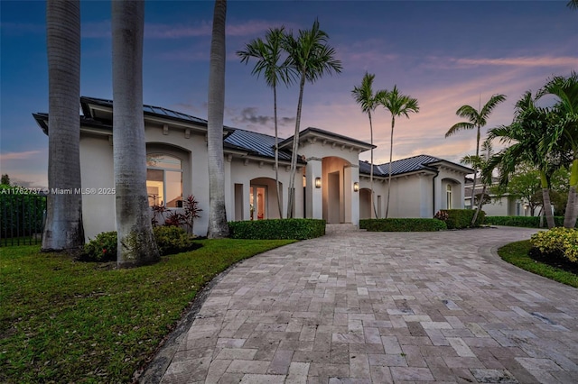 8111 SW 178th St, Palmetto Bay, FL 33157 - view of front of home featuring stucco siding, curved driveway, a standing seam roof, and metal roof