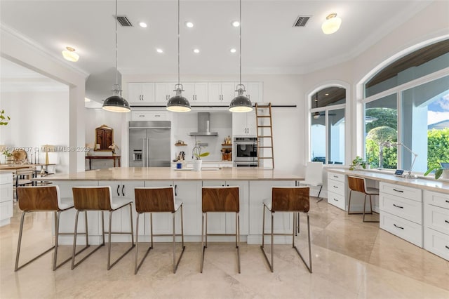 8111 SW 178th St, Palmetto Bay, FL 33157 - kitchen with wall chimney exhaust hood, visible vents, stainless steel appliances, and crown molding