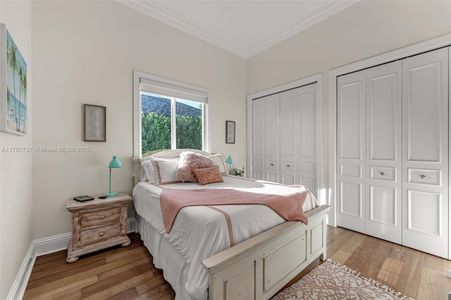 8111 SW 178th St, Palmetto Bay, FL 33157 - bedroom featuring baseboards, two closets, crown molding, and light wood finished floors