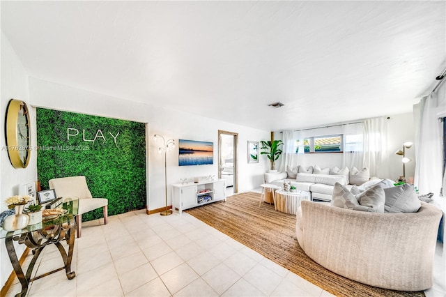 living room featuring light tile patterned floors and visible vents