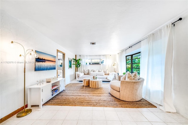 living area featuring visible vents and light tile patterned flooring