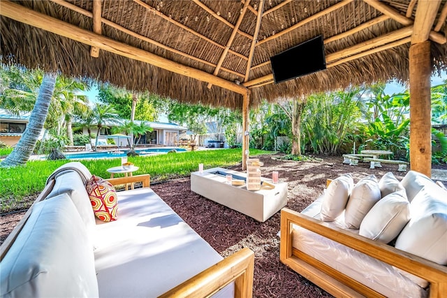 view of patio / terrace featuring a gazebo, an outdoor living space, and an outdoor pool