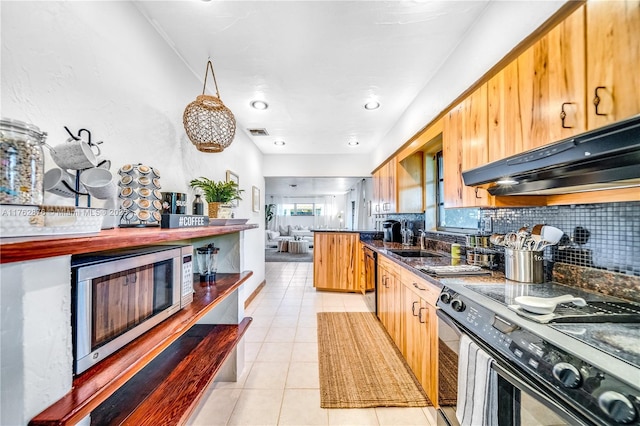 kitchen featuring under cabinet range hood, stainless steel microwave, dark countertops, backsplash, and black / electric stove