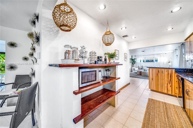 kitchen with light tile patterned floors, stainless steel microwave, visible vents, and recessed lighting