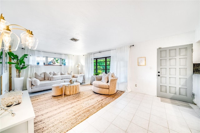 living area with light tile patterned floors and visible vents