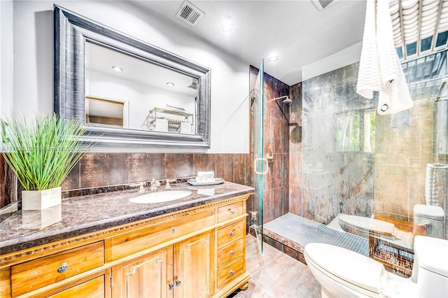 bathroom featuring visible vents, toilet, tile walls, and a stall shower