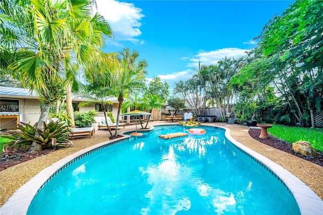 view of pool featuring a fenced in pool, a patio, and fence