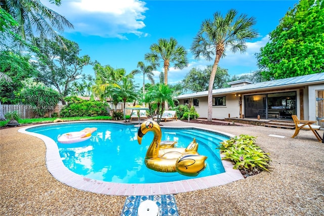 view of swimming pool with a patio, fence, and a fenced in pool