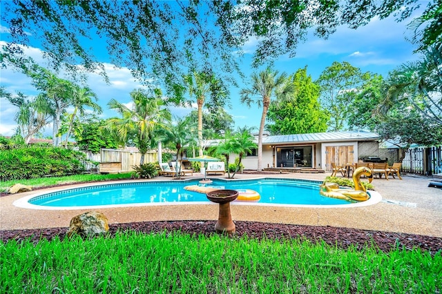 view of swimming pool featuring a fenced in pool, a patio, and fence
