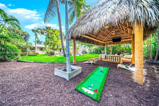 view of property's community with a gazebo and a lawn