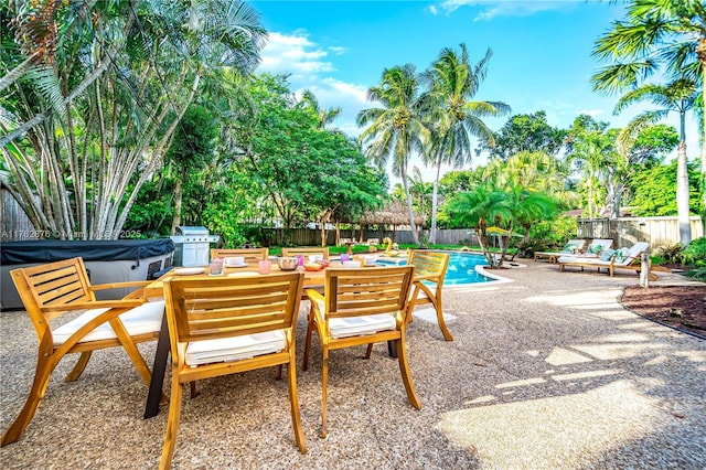view of patio with a fenced backyard, a fenced in pool, and a hot tub