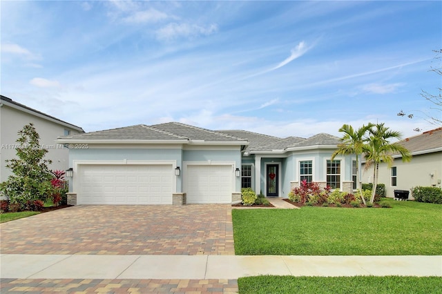 view of front of property featuring decorative driveway, a front lawn, an attached garage, and stucco siding