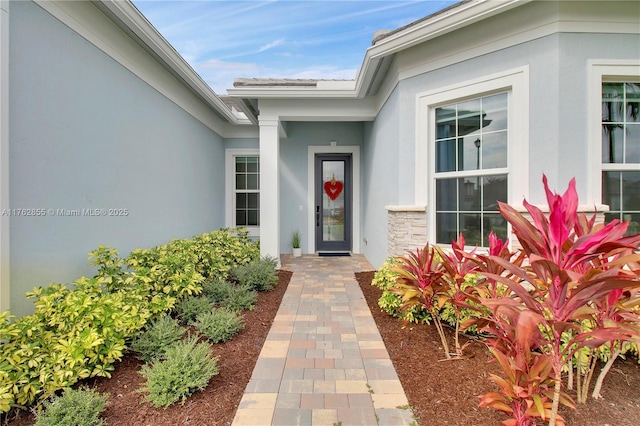 property entrance with stucco siding