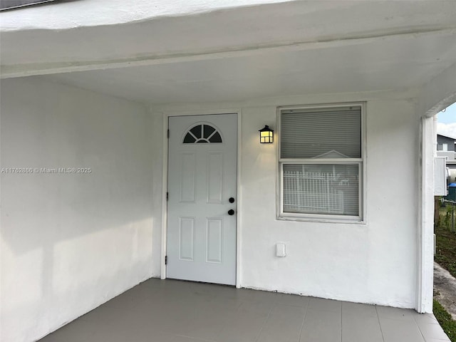 entrance to property with stucco siding