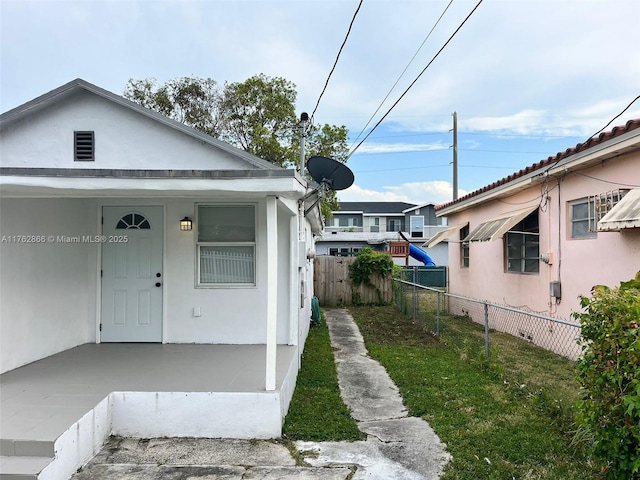 exterior space featuring fence and stucco siding