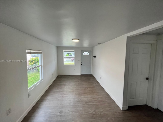 entrance foyer featuring dark wood finished floors, visible vents, and baseboards