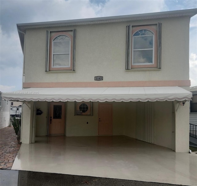 view of front of property with stucco siding and an attached garage