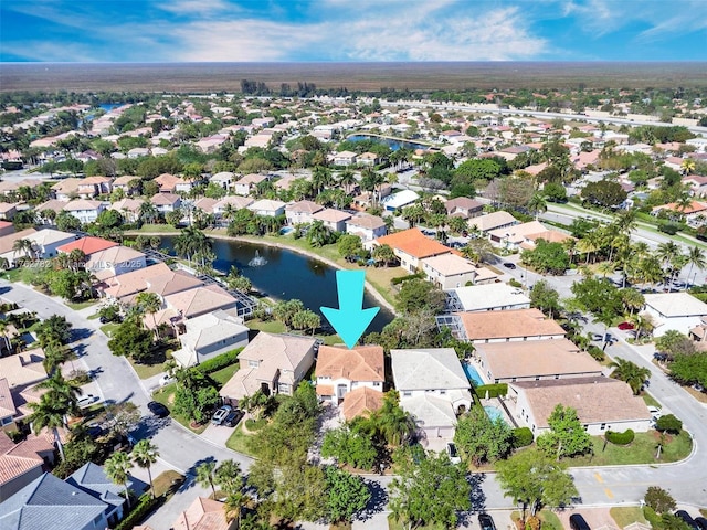 drone / aerial view featuring a residential view and a water view