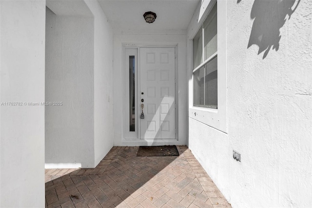 entrance to property with stucco siding