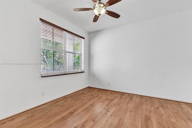 unfurnished room with light wood-type flooring, baseboards, and a ceiling fan