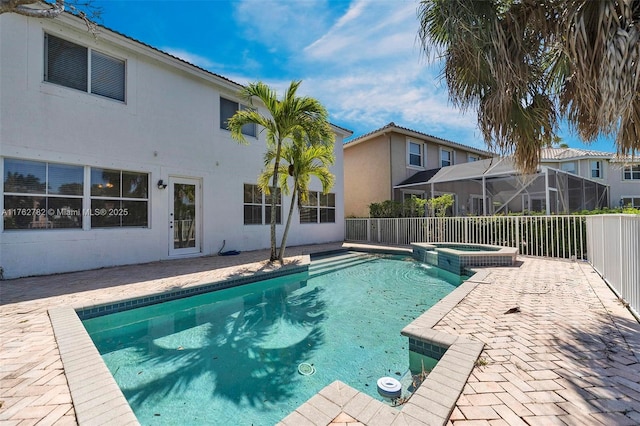 view of swimming pool with a patio area and a pool with connected hot tub